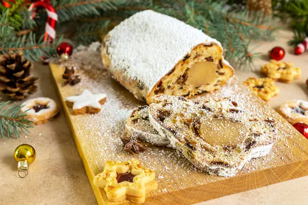 Stollen with marzipan.Traditional German Christmas cake or fruit bread with holiday decorations.