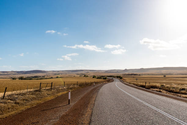 Empty winding asphalt road, highway in the middle of rural areas of Western Australia stock photo