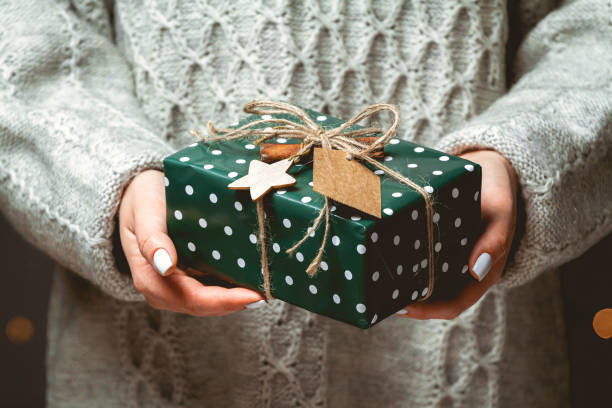 istock Cute Christmas gift in female hands 1283157014