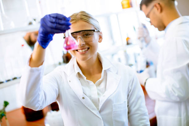 istock Young female scientist examining liquid in biochemical lab 1283158040