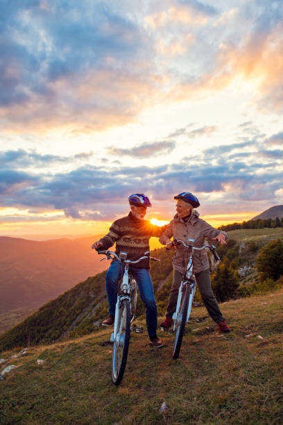 istock Active Senior Couple Riding Bikes In Park 1283158174