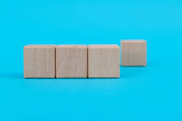 istock Wooden blocks in a row on blue background 1283158331