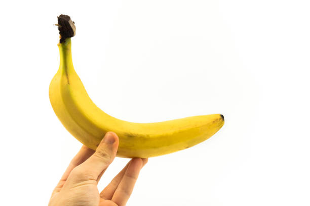 istock Banana in man's hand on white isolated background 1283159181