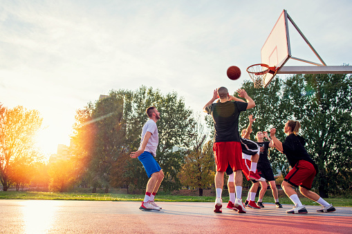 Group Of Young Friends Playing Basketball Match.