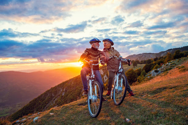 istock Active Senior Couple Riding Bikes In Park 1283162270