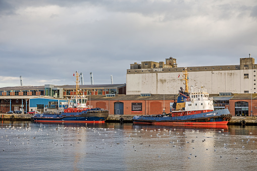 Aarhus Harbor, Denmark, October 19, 2020: Classic tugboats in an old industrial harbor
