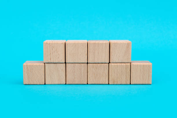 istock Wooden blocks in a row on blue background 1283164440