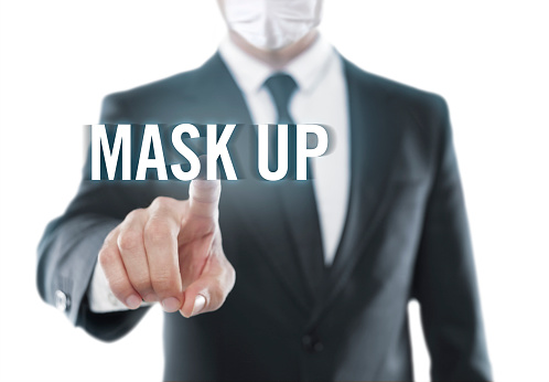 Businessman touching on a touchscreen with “mask up” text