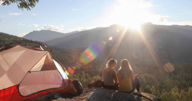 istock Young couple set up tent in mountains 1283165867