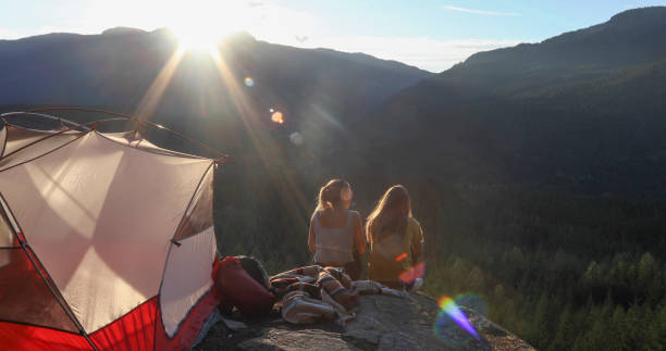 istock Young couple set up tent in mountains 1283165872