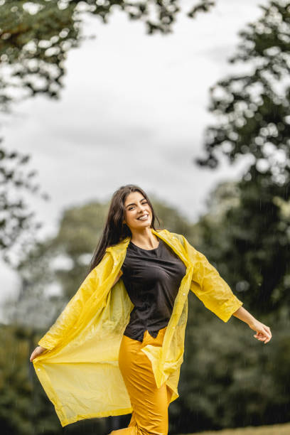 istock Happy young beautiful woman having fun while dancing on a rain in nature 1283166192