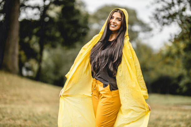 istock Happy young beautiful woman having fun while dancing on a rain in nature 1283167219