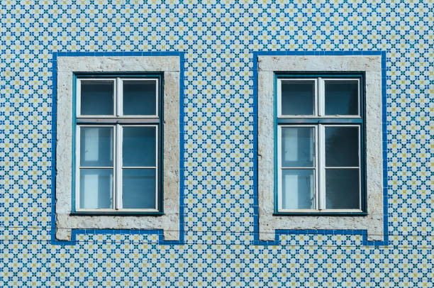 Lisbon windows with typical portuguese tiles on the wall