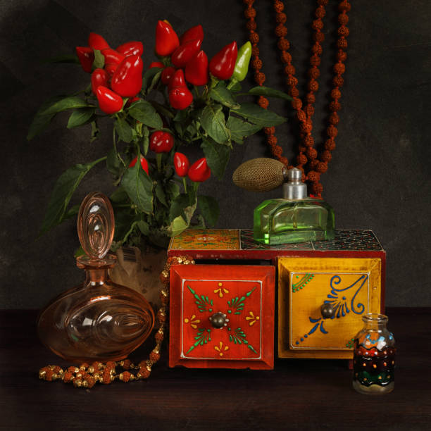 Vintage still life with perfume Vintage still life with perfume, jewelry boxes and decorative pepper plants perfume sprayer photos stock pictures, royalty-free photos & images