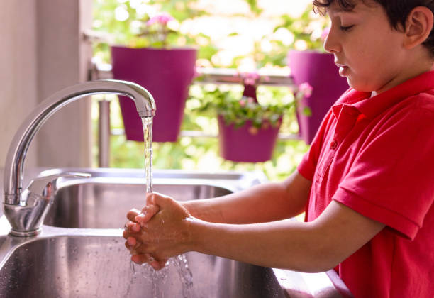 istock Child is washing hands with antibacterial soap - Covid-19 virus disease prevention 1283171665