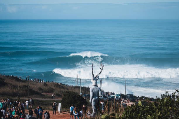 Crowd on cliff at North Beach waves impressive swell and waves of courages surfers, Portugal Nazare, Portugal - October 29, 2020: Crowd on cliff at North Beach waves impressive swell and waves of courages surfers, Portugal nazare surf stock pictures, royalty-free photos & images