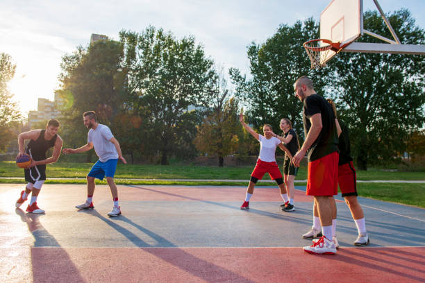 istock Group Of Young Friends Playing Basketball Match 1283173538