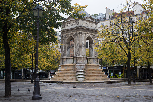 Paris  France - 24 October 2020 - view of stoned fountain on cozy place in chatelet quarter