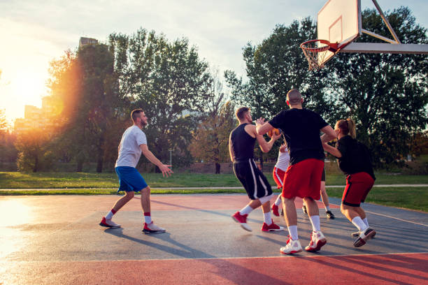 istock Group Of Young Friends Playing Basketball Match 1283173961