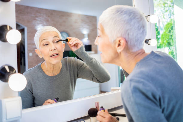 istock Beautiful mature woman applying mascara. 1283174776