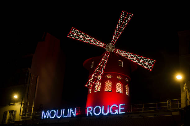 the famous "moulin rouge" ( the red  mill in english)  cabaret illumined in the  night Paris - France - 23 October 2020 - View of the famous "moulin rouge" ( the red  mill in english)  cabaret illumined in the  night place pigalle stock pictures, royalty-free photos & images