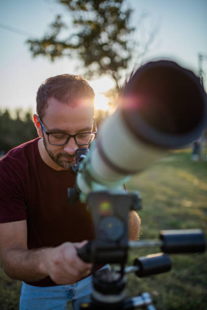 istock Amateur astronomer looking at the sky with a telescope. 1283176220