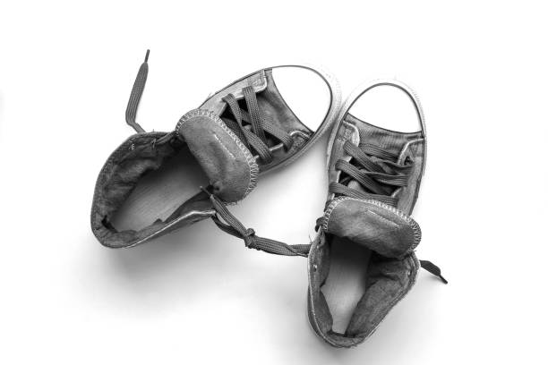 a pair of canvas shoes are in a rattan basket