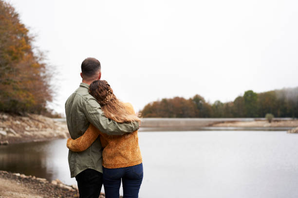 istock Back view of lovely young couple hugging. 1283179693