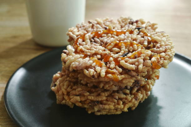istock Thai sweet crispy rice cracker with sugar cane baking watermelon juice dressing caramel eat couple hot tea 1283180925