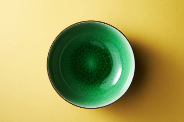 empty green bowl on yellow background