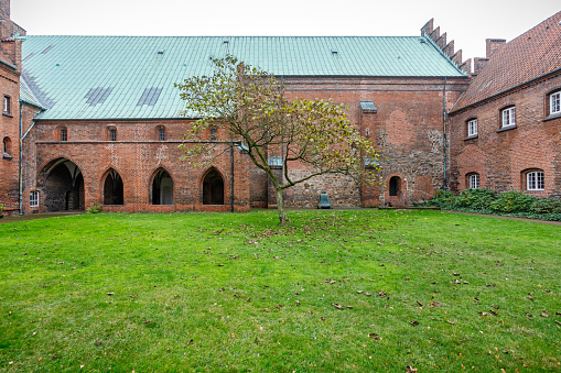 Vor Frue Kirke, Church of Our Lady, Aarhus, Denmark, October 21, 2020: The inner square of a cloister. The church dates to 1060 but where expanded in 1240 where it became part of a Dominican priory. After the reformation in 1521 it became a Lutheran church, which it still is.