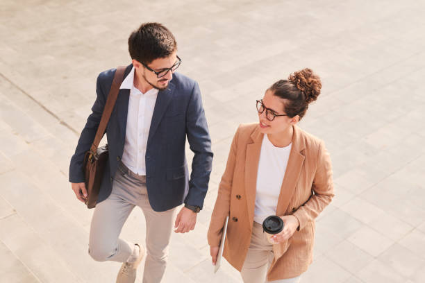 istock Two young elegant brokers in smart casualwear discussing work at coffee break 1283189228