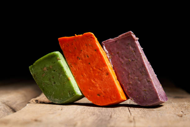 istock Three different gourmet cheeses on rough woode planks 1283189452