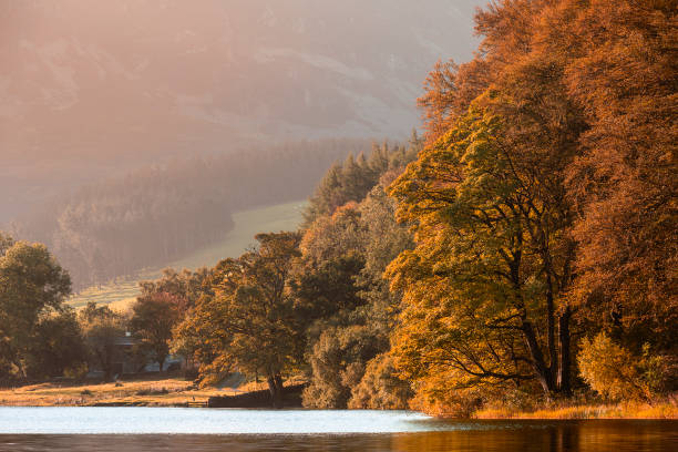 Stunning epic sunrise landscape image looking along Loweswater towards wonderful light on Grasmoor and Mellbreak mountains in Lkae District stock photo