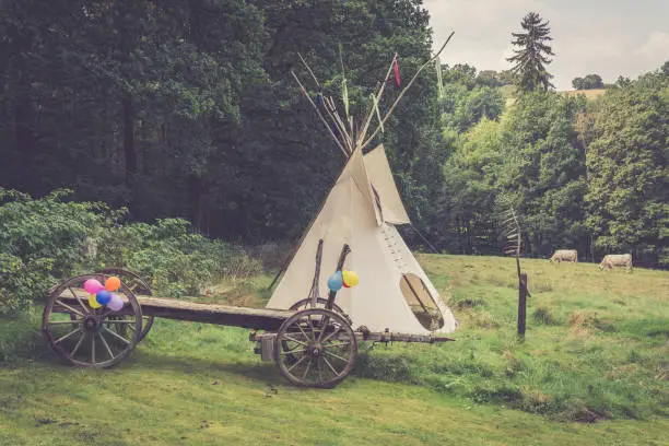 an Indian tent with a horse trailer in nature