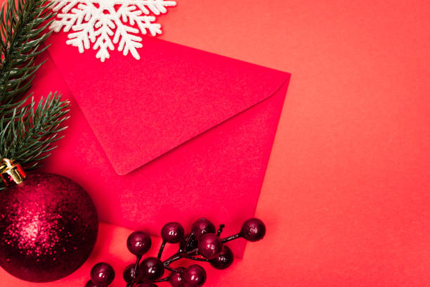 istock top view of Christmas decoration and envelope on red background 1283191584
