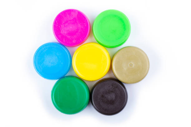 istock Group of multi colored bottle caps on a white background. Recycling and reuse concept. Space for text. 1283191882