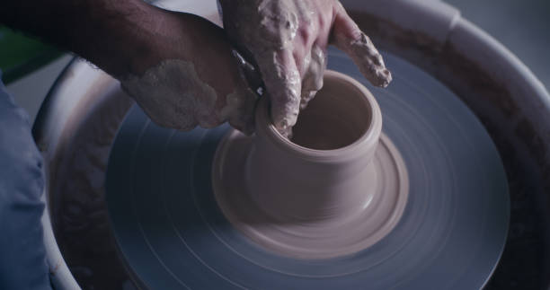 istock Crop ceramist creating pot on spinning wheel 1283194256