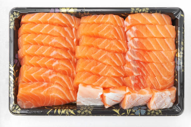 istock Fresh salmon sashimi serve on take a way tray isolated on white background. 1283198661