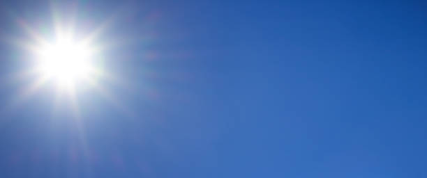 istock natural background of sun rays on a blue sky, sunny day 1283200705