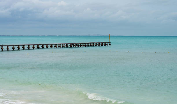 istock A pier on the beach with crystal clear water and white sand 1283202862