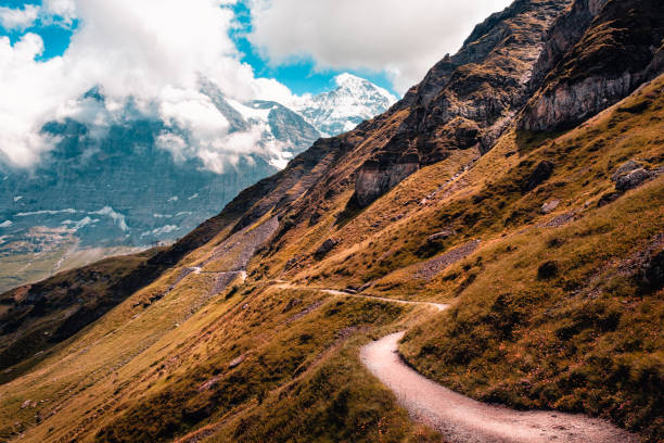 A small hiking high up in the Bernese Alps with famous mountains Eiger and Jungfrau in the background. Switzerland