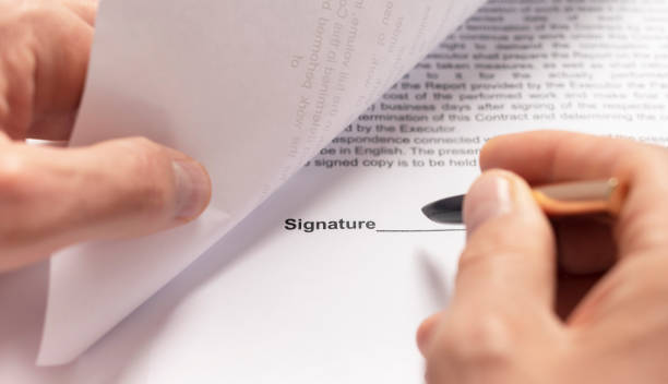 istock Contract signing concept. Businessman hand with pen over document closeup 1283207004