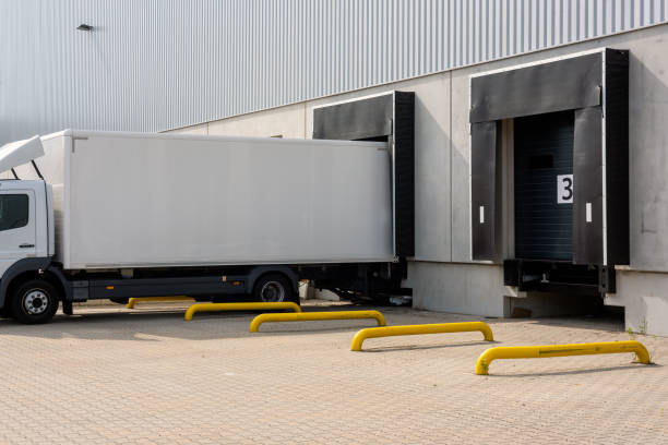 istock trucks at loading ramps of a warehouse 1283207207