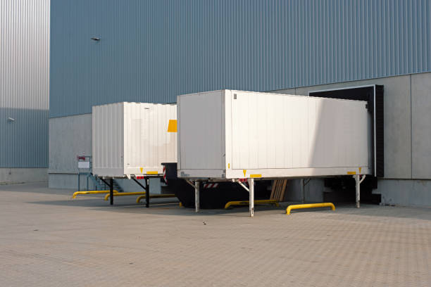 istock trailers waiting at loading ramps of a warehouse 1283208018