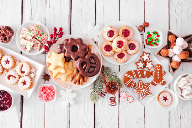 istock Christmas sweets and cookies. Overhead view table scene on a white wood background 1283209420
