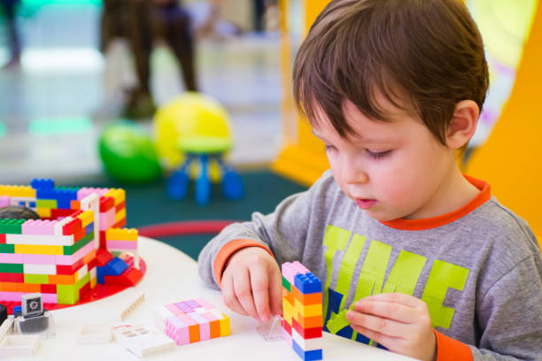 istock The child collects a constructor . Kids activity in kindergarten or at home 1283209844