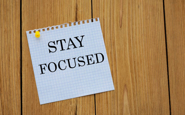 istock STAY FOCUSED - words on white paper attached to a wooden board 1283210872