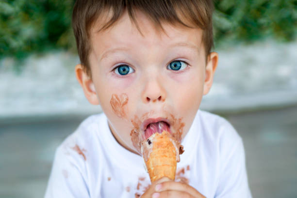 istock kid boy eating ice cream 1283211988