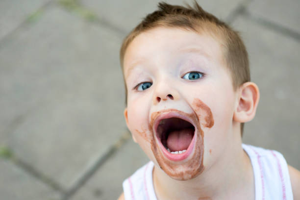 istock boy smeared ice cream. dirty boy 1283212010